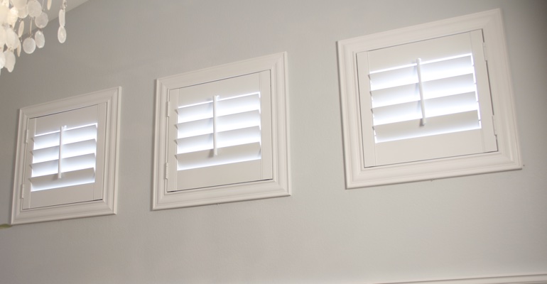 Shutters on square windows in laundry room